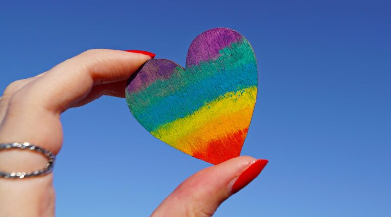 person holding multicolored heart decor