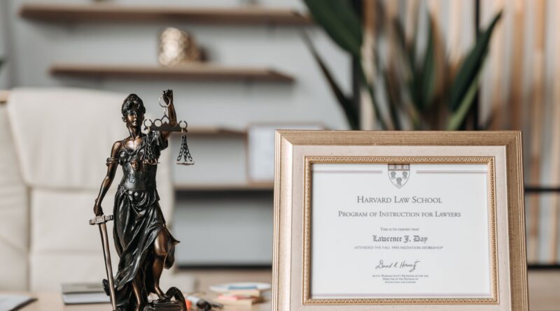 selectvie focus photo of a lady justice statuette and diploma