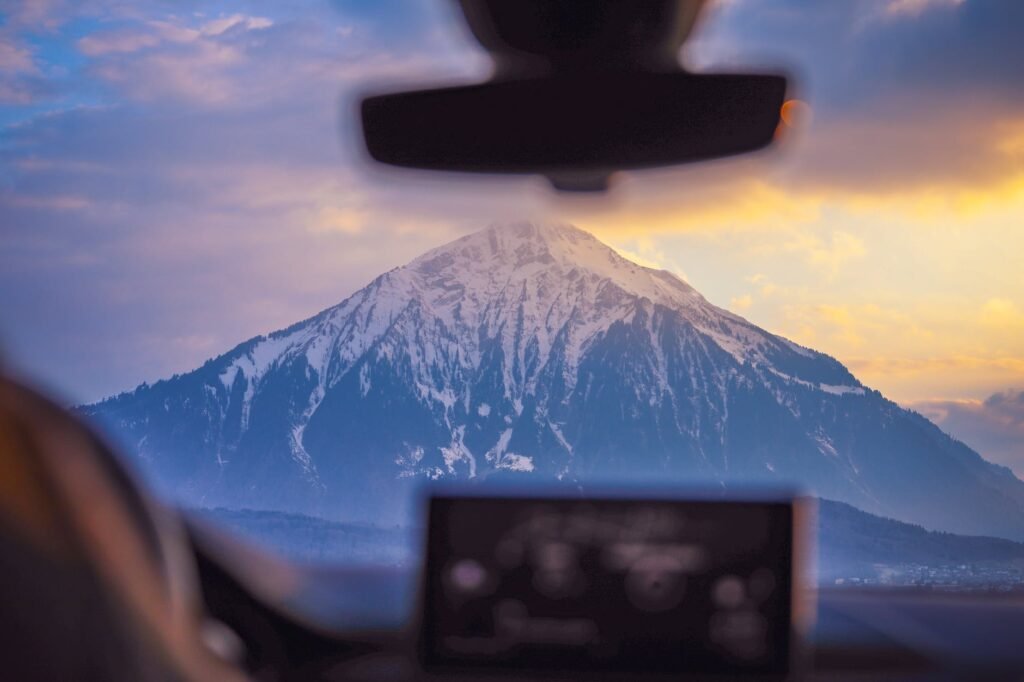 photo of snow capped mountain through windshield
