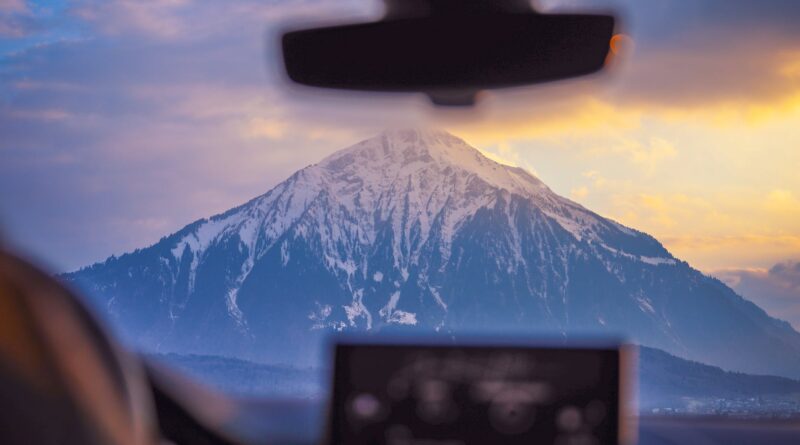 photo of snow capped mountain through windshield