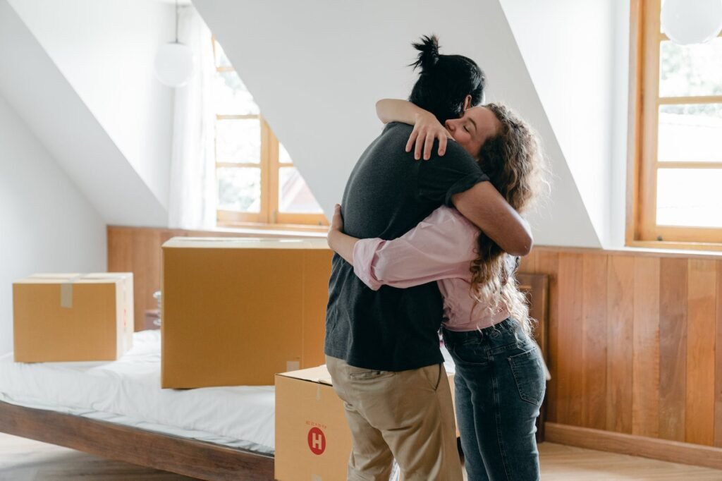 happy diverse couple hugging in new house