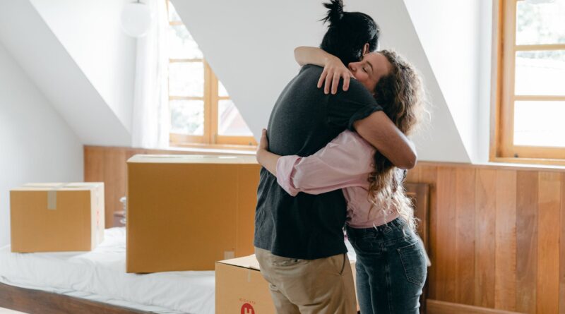 happy diverse couple hugging in new house