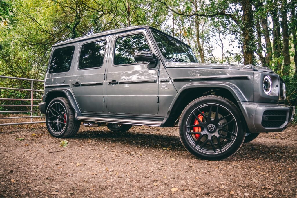 photo of mercedes benz g class parked on dirt road