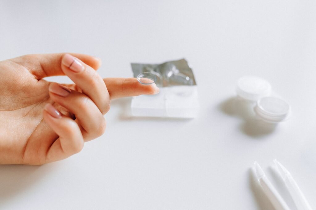 close up photo of contact lens on finger